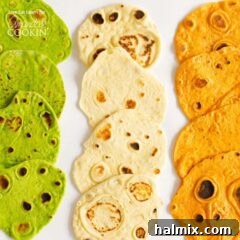 An overhead picture of three different kinds of homemade tortillas laying on a white platter.