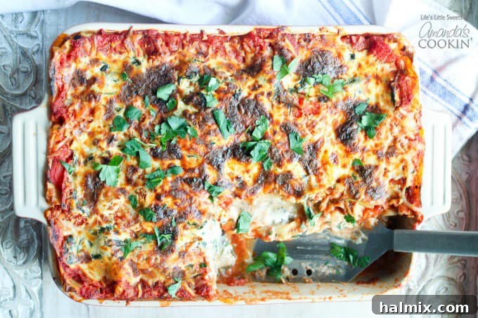 Hearty Garden Lasagna 4 pan of veggie lasagna, slice removed, spatula where slice was