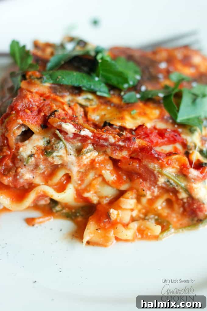 Hearty Garden Lasagna 6 A close up of veggie lasagna on a white plate.