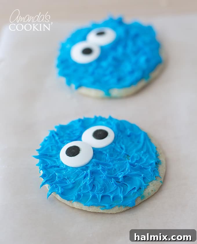 Cookie Monster and Elmo's Cookie Fun 8 Close-up of a finished Cookie Monster decorated cookie on a white table with another cookie in the background
