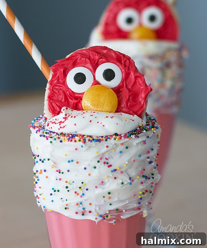 A child happily drinking an Elmo Freakshake, demonstrating how much kids love this festive treat.
