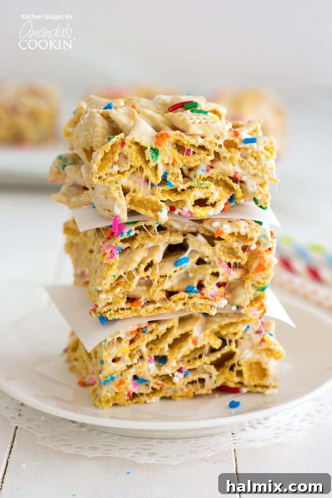 Stack of colorful funfetti marshmallow cereal bars, showcasing their thick, chewy texture and vibrant sprinkles.