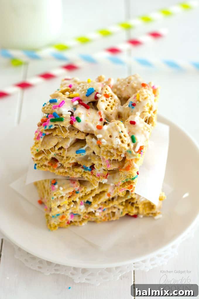 A stack of three funfetti marshmallow cereal bars, showing the colorful sprinkles and inviting texture, ready to be enjoyed.