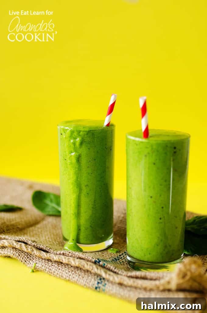 Green smoothies are an ultra simple, delicious way to kick off your day! Perfect for a healthy on-the-go breakfast or lunch packed with veggies and fruit. Two vibrant green smoothies on a bright yellow background, garnished with fresh mint, a sliced banana, and red paper straws.