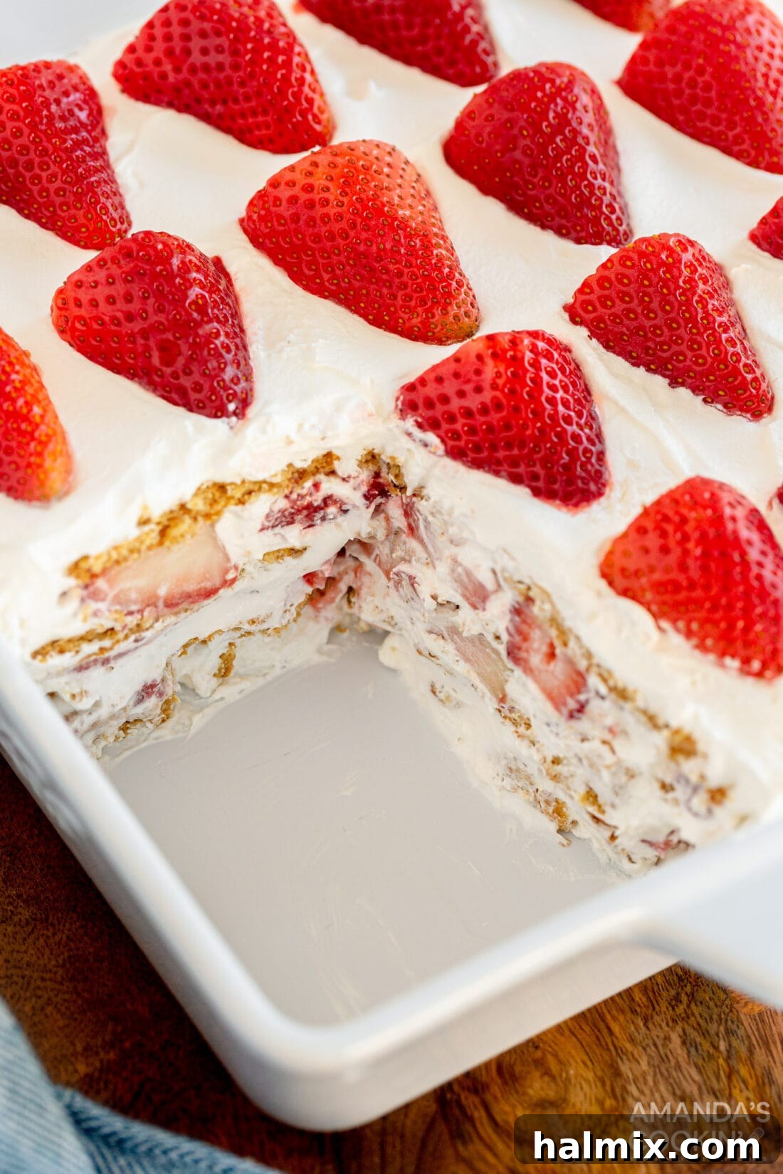 Strawberry icebox cake with a slice removed, revealing the beautiful layers.