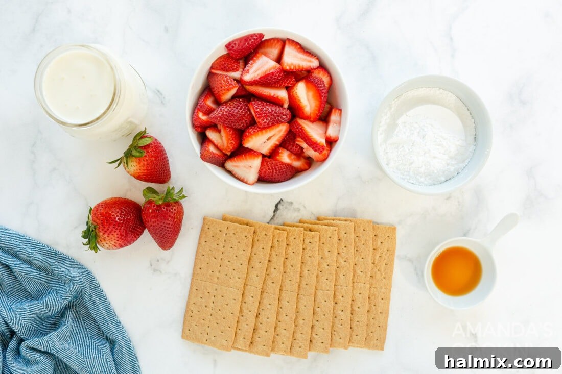 Ingredients for Strawberry Icebox Cake laid out on a table: heavy cream, powdered sugar, vanilla extract, fresh strawberries, and graham crackers.