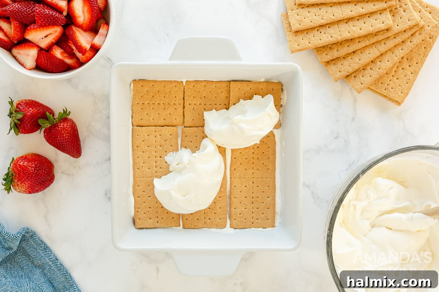 Graham crackers covering the whipped cream layer, ready for more topping.
