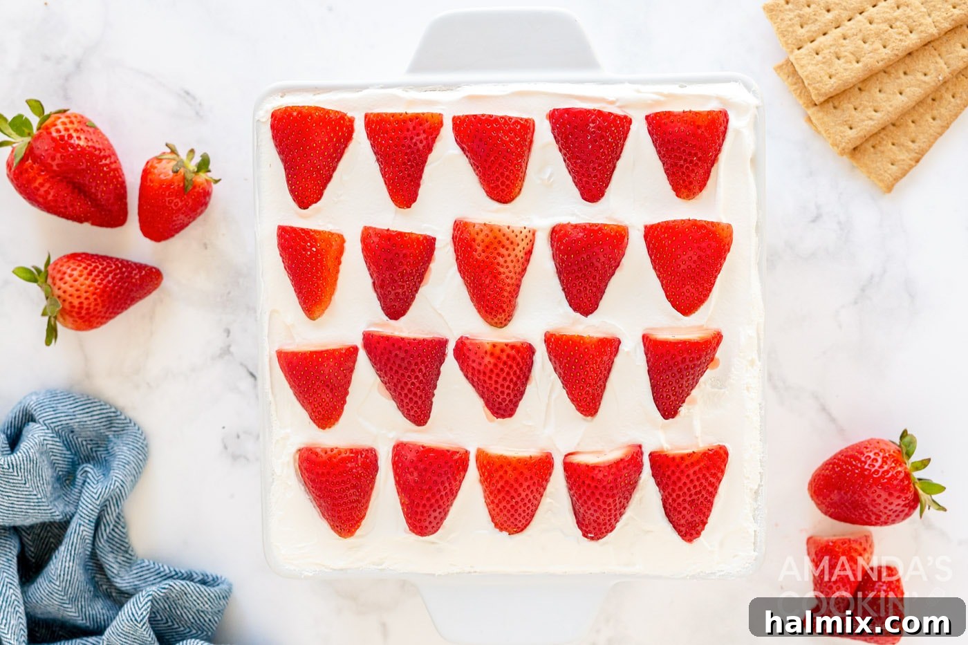 Overhead shot of the finished top layer of sliced strawberries, arranged decoratively.
