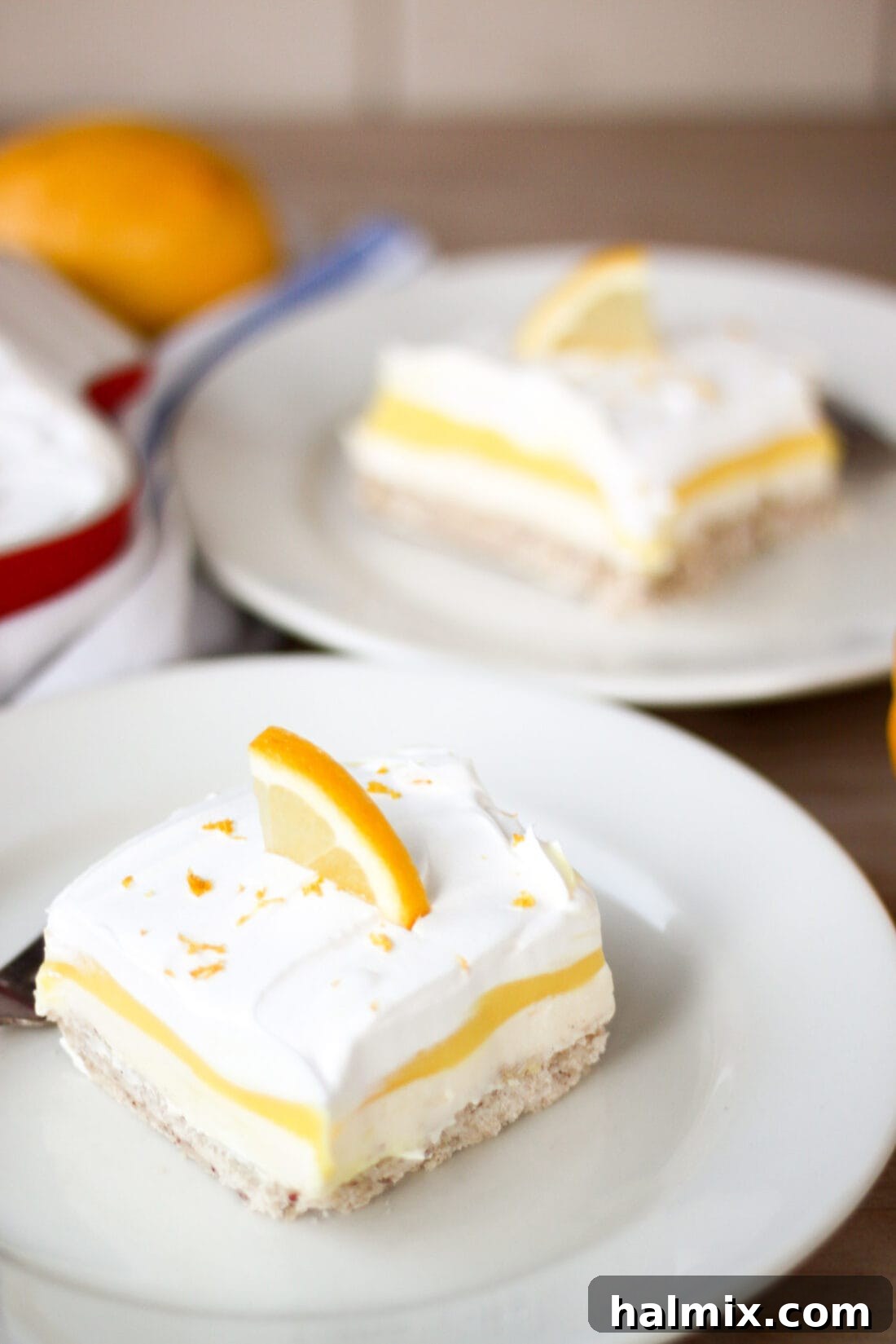 Two pieces of Lemon Lush on plates