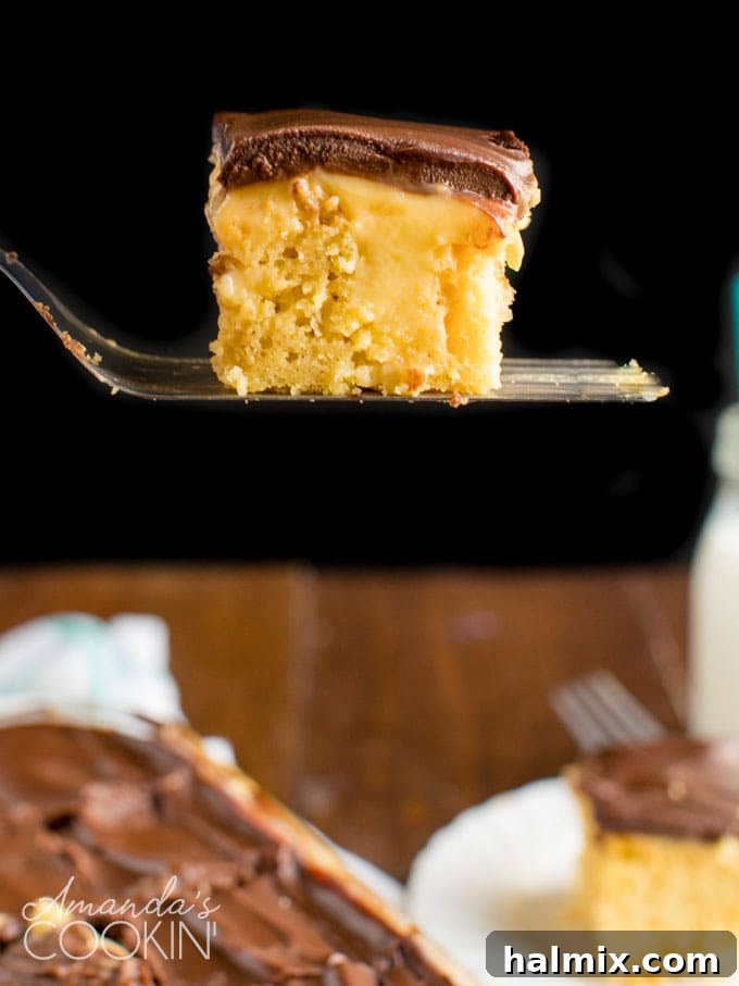 spatula holding a slice of poke cake