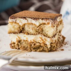 Close up photo of a slice of Tiramisu Icebox Cake on a plate