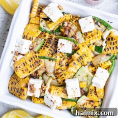 Grilled Corn & Zucchini Salad with Feta, close-up in a bowl, showcasing its fresh ingredients