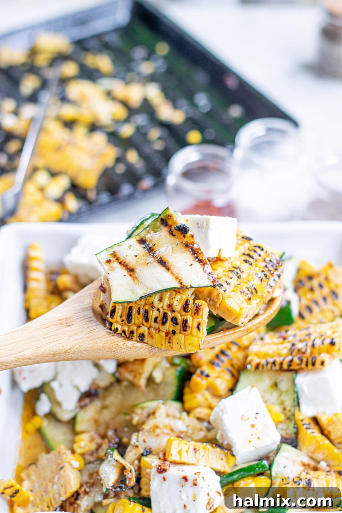 Serving a portion of Grilled Corn & Zucchini Salad with Feta, highlighting its fresh appeal and vibrant colors