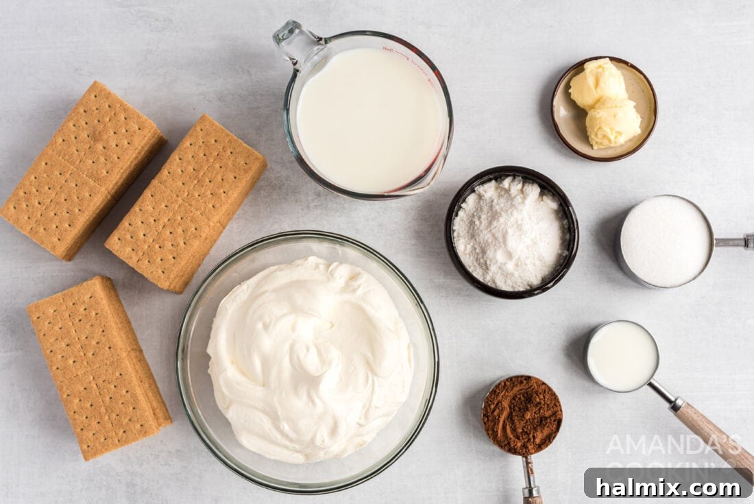 A flat lay of all the fresh ingredients perfectly laid out on a kitchen counter, ready for making the eclair cake, including milk, pudding mix, whipped topping, graham crackers, cocoa, sugar, and butter.