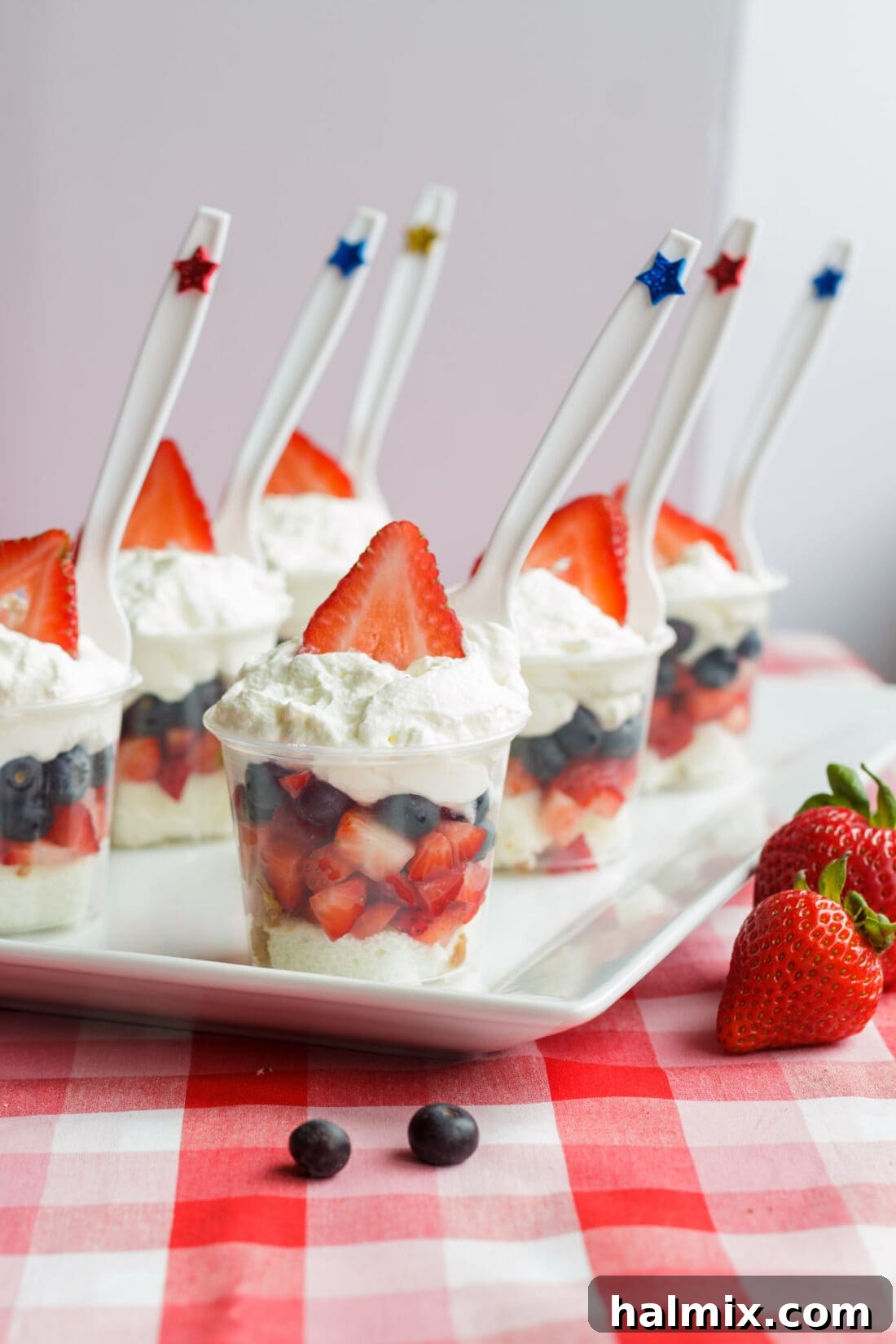 Mini Shortcake Cups are perfect for Memorial Day, 4th of July or just any time. These adorable little fruit and cake cups are just the right size. A festive platter filled with an array of Mini Shortcake Cups, showcasing their vibrant colors and appealing individual portions.
