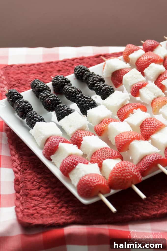Patriotic American Flag Kabobs: An Easy Fruit and Cake Dessert for Memorial Day or Fourth of July gatherings American Flag kabobs made from fresh fruit and tender angel food cake, perfectly arranged for a patriotic celebration