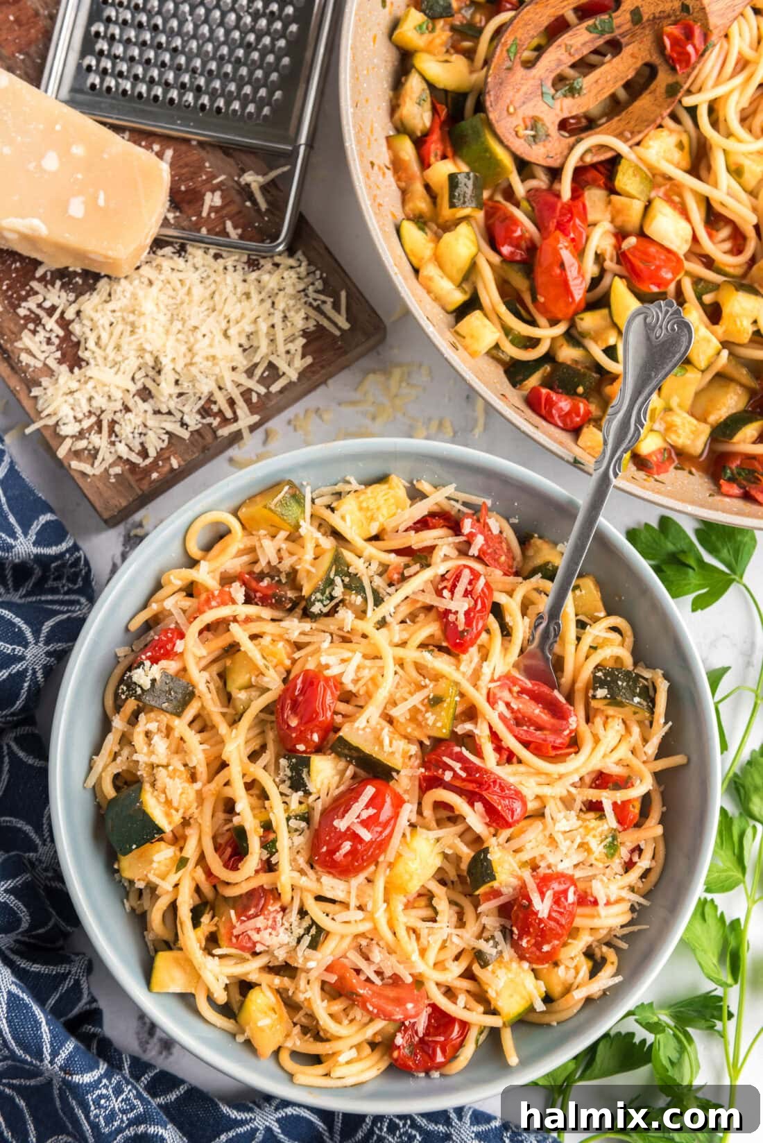 Bowl of Simple Zucchini Tomato Pasta topped with parmesan 