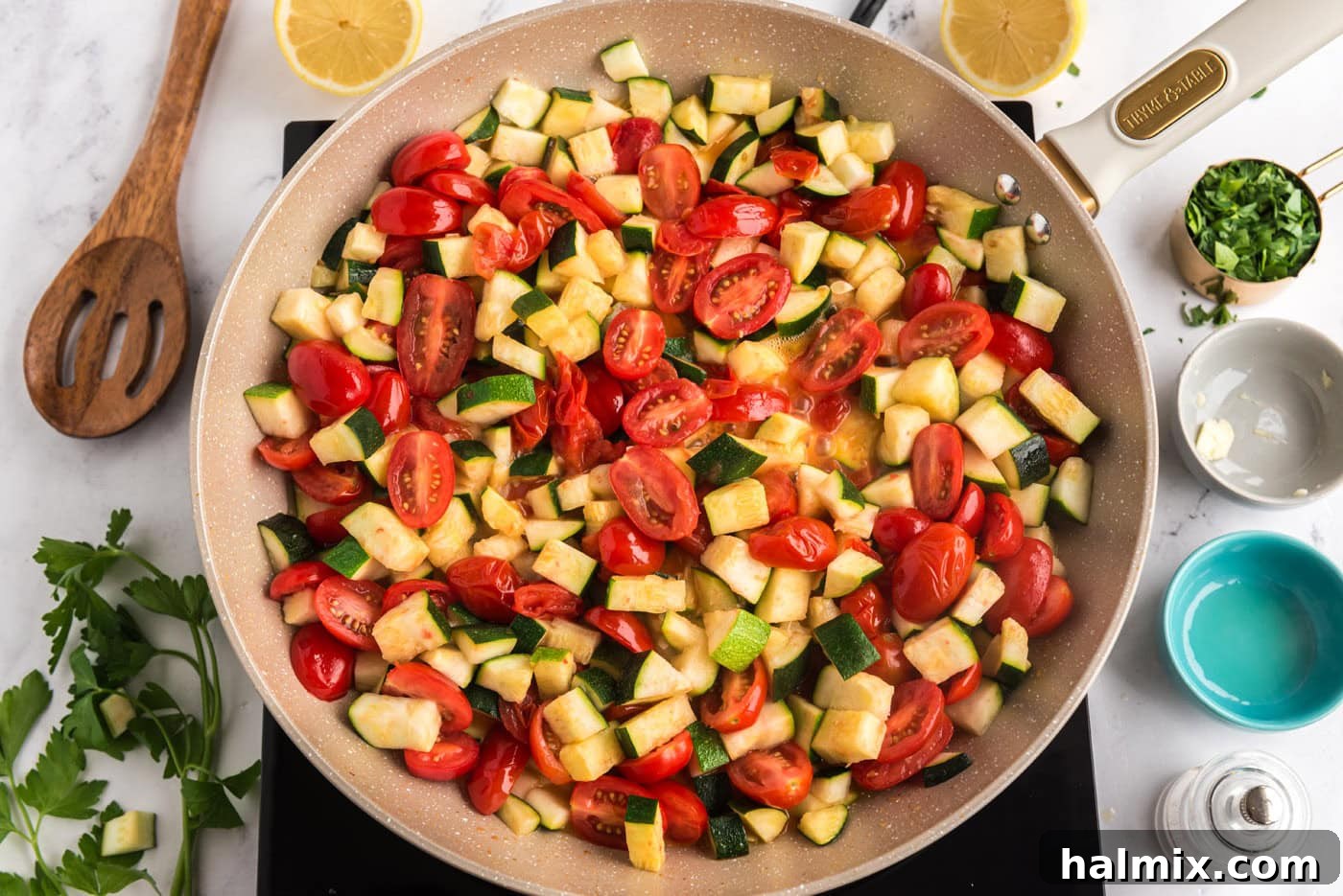cooked zucchini and tomatoes in a skillet