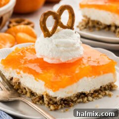 Orange Pretzel Salad on plate with whipped cream