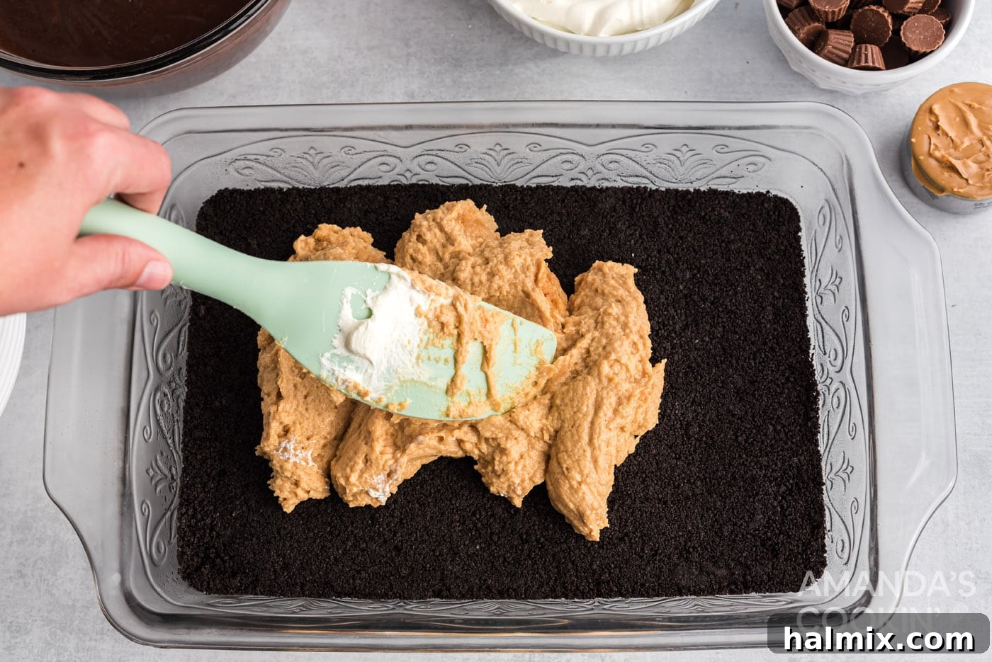 rubber spatula spreading out cream cheese peanut butter mixture