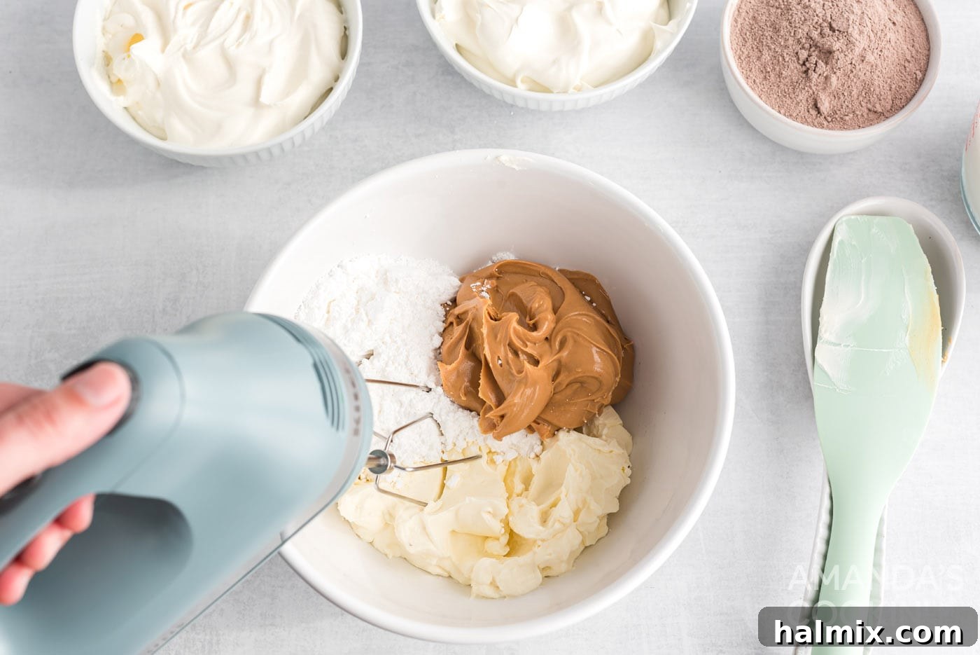 mixing peanut butter, powdered sugar and cream cheese in a bowl