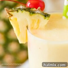 Close up of a vibrant rum cocktail, showing its smooth, blended texture and inviting garnishes.