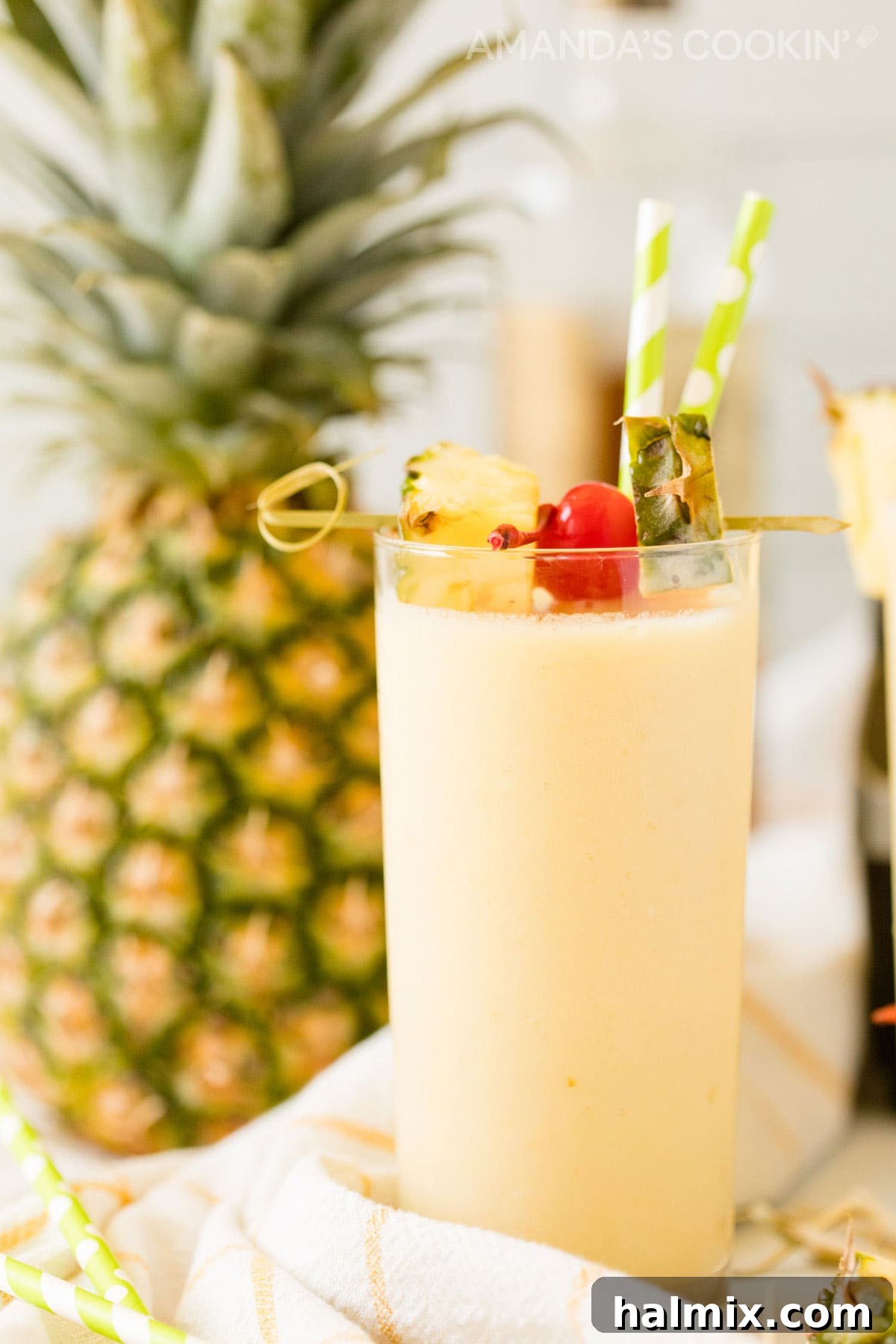 Side view of a perfectly blended pineapple rum slush cocktail, showcasing its smooth, creamy texture and tropical appeal, ready to be enjoyed.