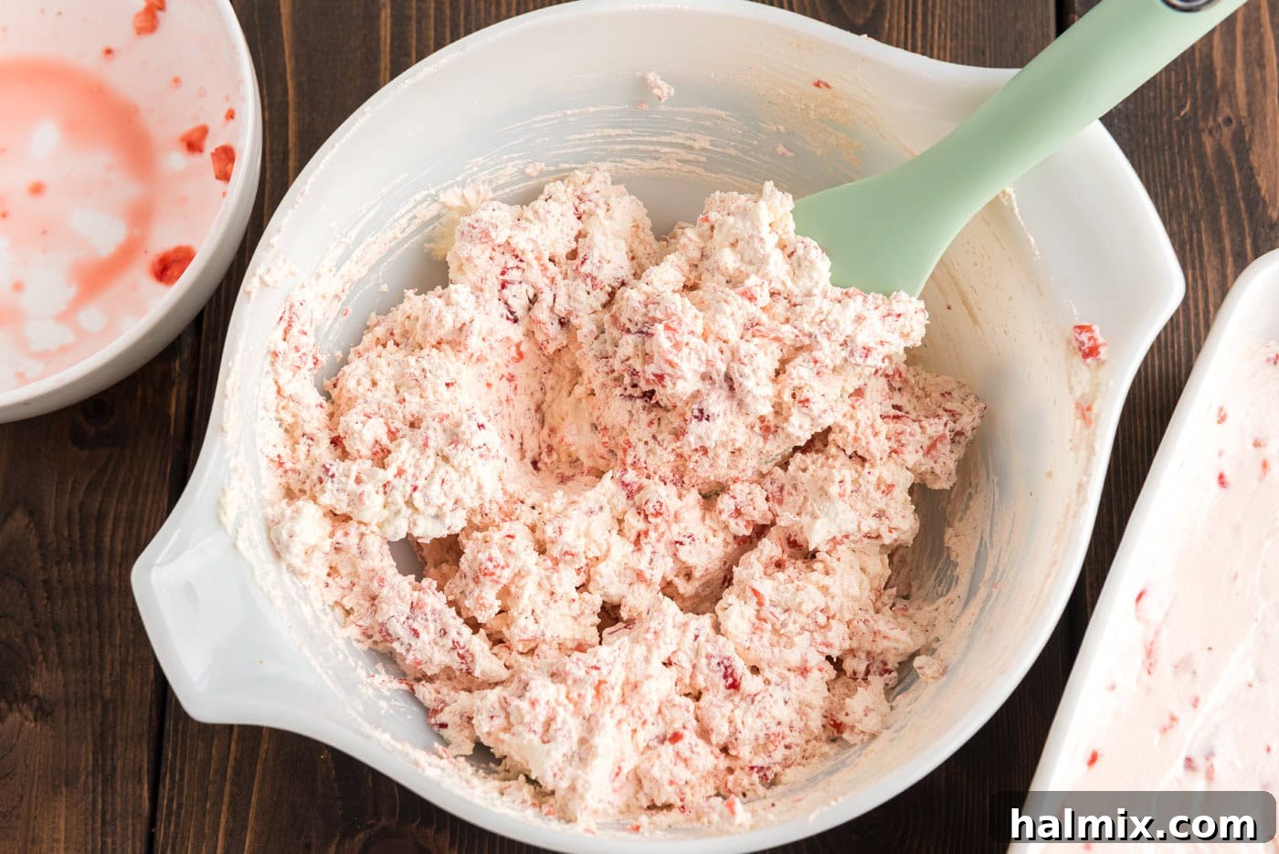 Strawberry and cool whip mixed in a bowl