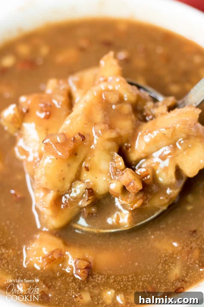 A vibrant close-up of Bananas Cream Lush with Bananas Foster sauce, garnished with fresh banana slices and nuts.