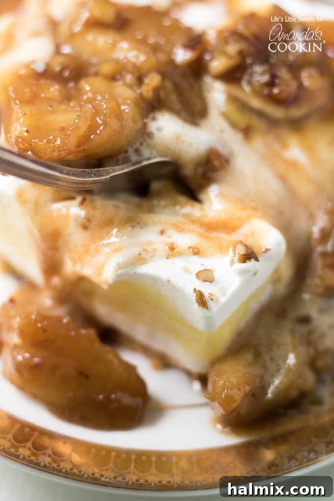 A close-up of caramel sauce being drizzled over a slice of Banana Cream Lush, highlighting its rich texture.