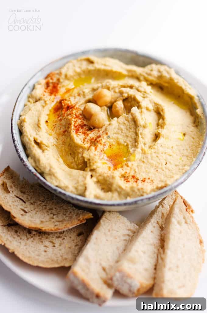 Baba Ganoush Hummus: A Delicious Fusion of Eggplant and Chickpea Dips – Perfect for Healthy Appetizers and Vegetarian Meals Creamy Baba Ganoush Hummus served in a bowl with fresh pita bread and vegetables