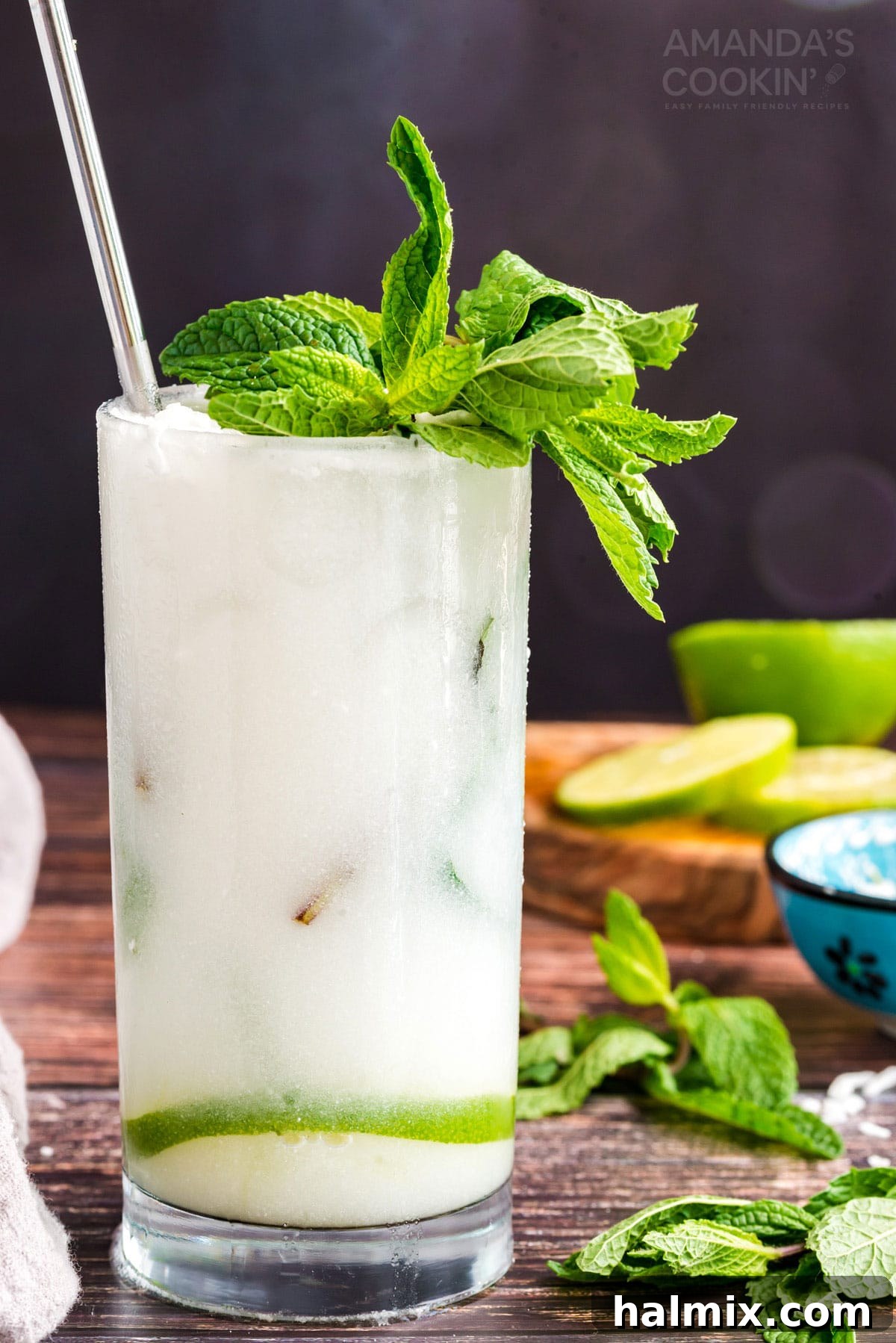 A close-up of a refreshing coconut mojito cocktail in a glass, with mint and coconut rum visible, ready for enjoyment.