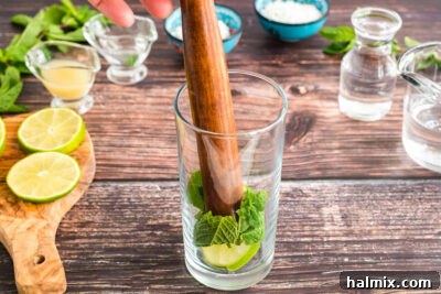 muddling mint and lime in glass