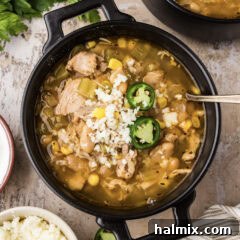 Close up photo of a bowl of Crockpot White Chicken Chili, showing a rich, creamy texture
