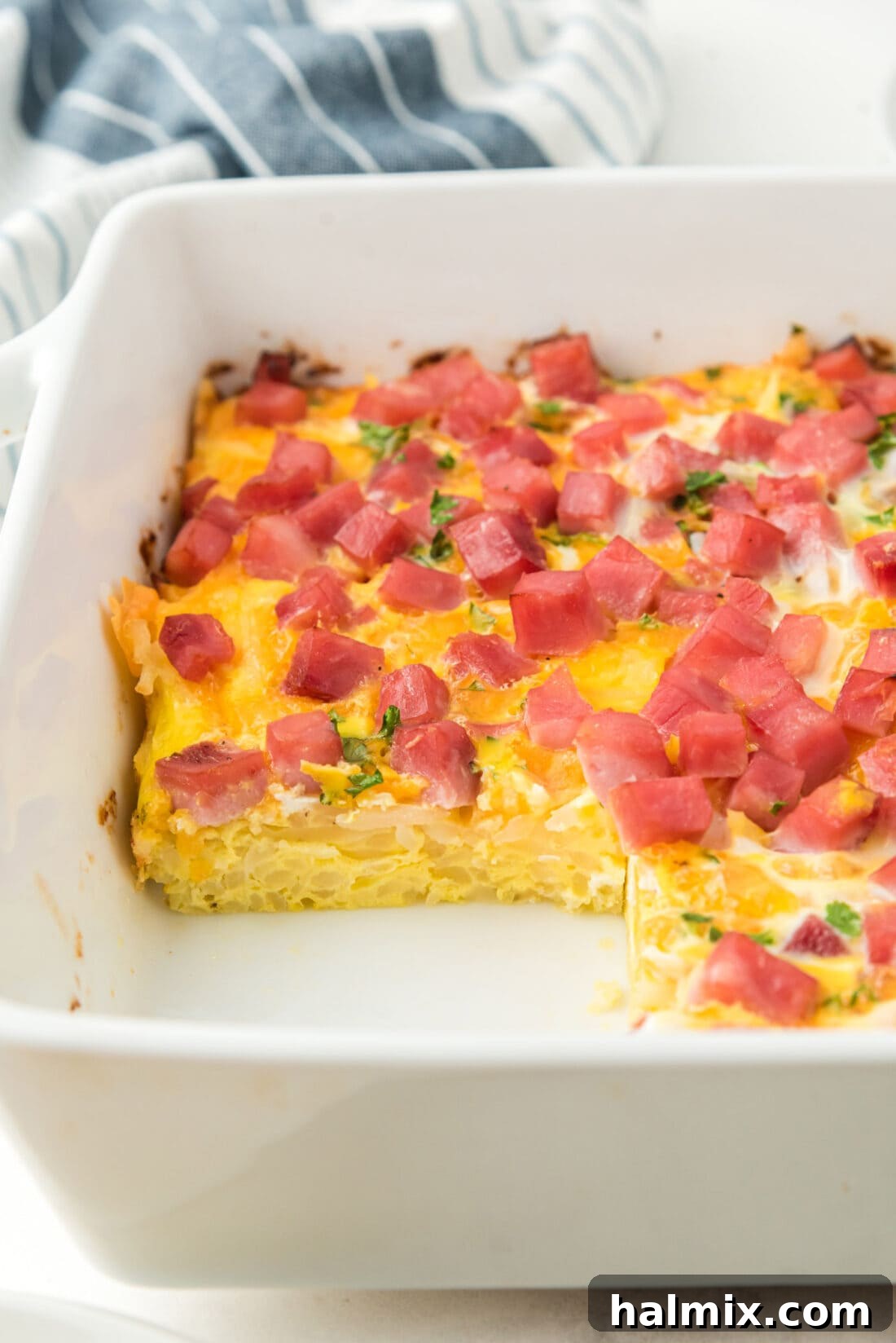A full pan of golden-brown breakfast casserole, freshly baked and ready to be served, showing its crispy edges and melted cheese.