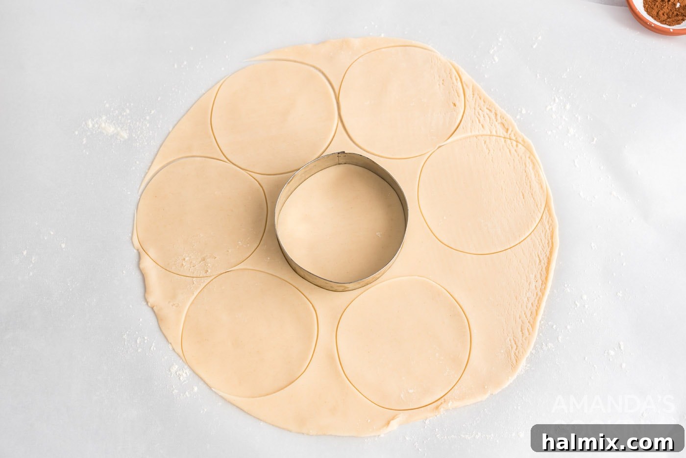 cookie cutter cutting into pie crust