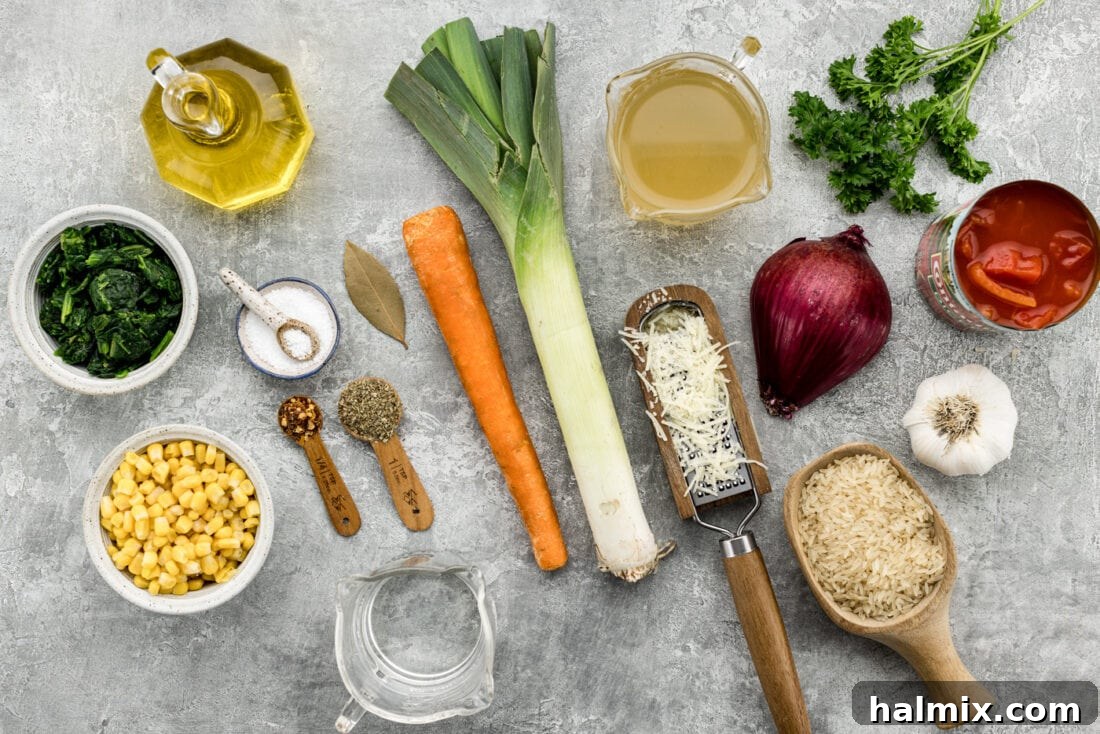 Garden Harvest Rice Soup 4 Ingredients for Vegetable Rice Soup laid out on a cutting board, including carrots, spinach, leeks, corn, tomatoes, and rice.