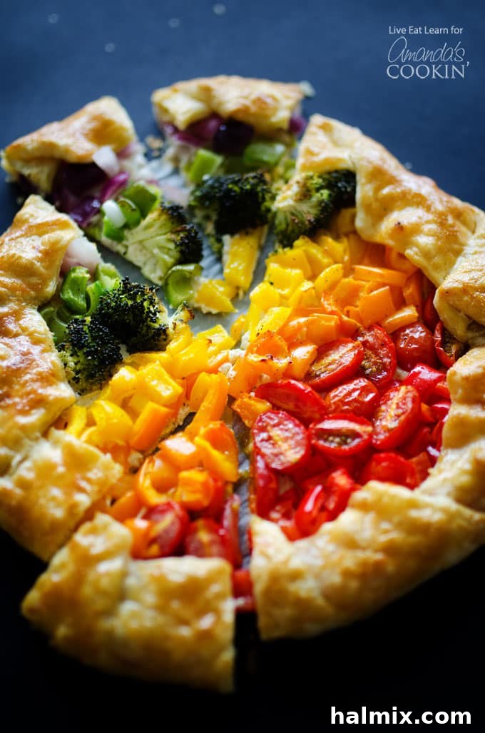 Vegetable Rainbow Tart: A stunning, easy-to-make savory tart with puff pastry and a creamy ricotta base, packed with colorful vegetables. Ideal for a vibrant side dish, appetizer, or light meal. #vegetablerainbowtart #savorytart #puffpastryrecipe #ricottatart #colorfulveggies #easyvegetarian A beautifully arranged Vegetable Rainbow Tart, bursting with colorful vegetables and a golden crust, ready to be served. A perfect savory tart or impressive side dish.