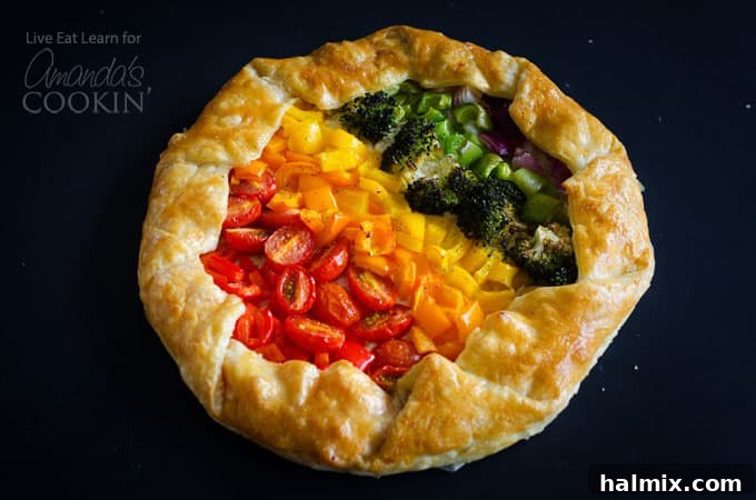 Vegetable Rainbow Tart: A stunning and easy savory tart, perfect as a colorful side dish or appetizer. A freshly baked Vegetable Rainbow Tart, golden brown and glistening, shown whole on a cutting board, ready to be sliced and served.