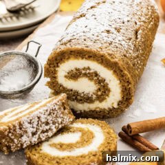 A complete Pumpkin Cake Roll with two neatly cut slices resting in front, inviting you to indulge.