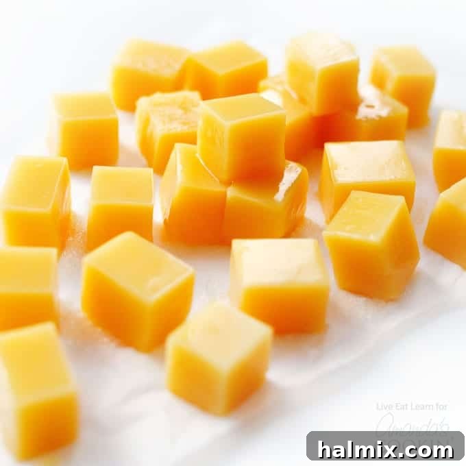 Squares of delicious Orange Creamsicle Homemade Gummies, a light and satisfying treat. #homemadecandy #gummyrecipe #orangesnacks #easysnacks Close-up of perfectly set, square-shaped orange creamsicle gummies, ready for enjoyment.