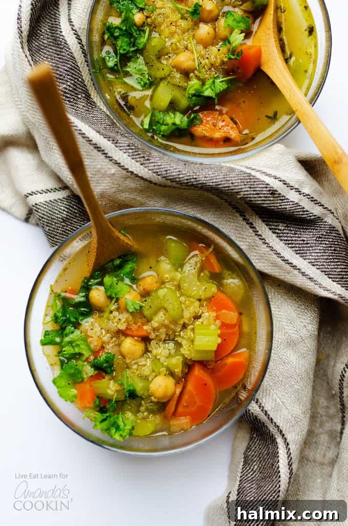 Nourishing Chickpea and Quinoa Vegetable Soup for a Cozy Winter Meal Hearty chickpea and quinoa vegetable soup served in a rustic bowl, garnished with fresh herbs, showcasing its rich texture and vibrant vegetables.