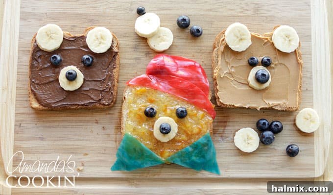 A child's hands decorating a Paddington Bear toast with fruit roll-ups