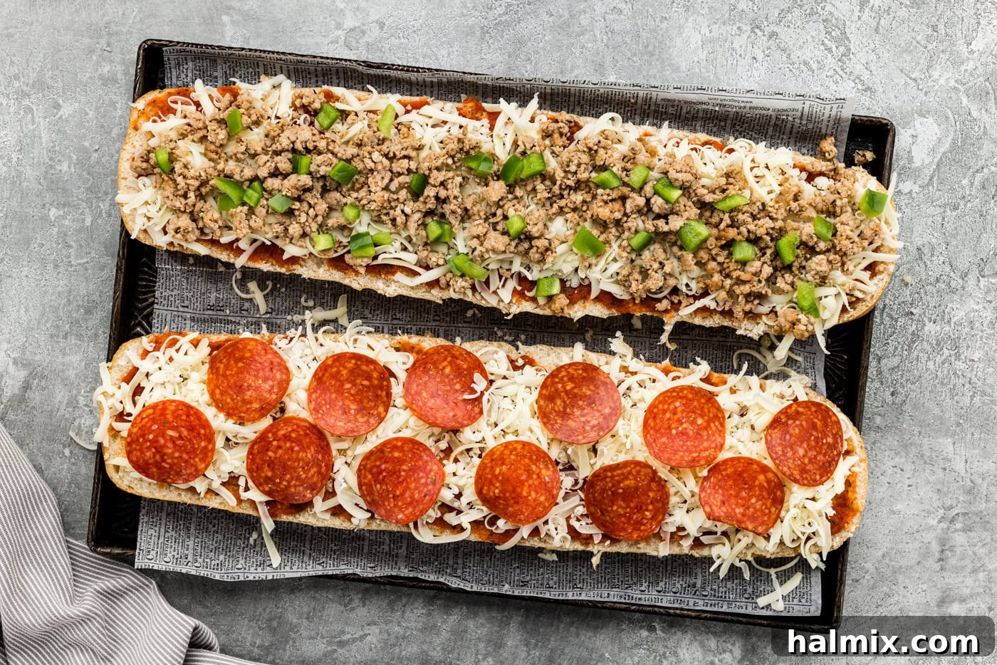 Cheese and pizza toppings added on top of French bread slices