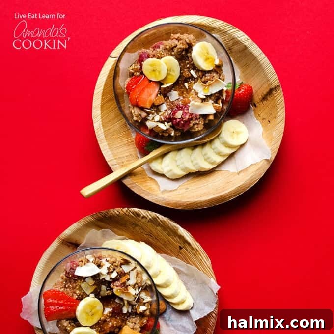 Delicious Slow Cooker Breakfast Quinoa with Fruit Toppings Bowl of cooked slow cooker breakfast quinoa with sliced bananas and fresh strawberries