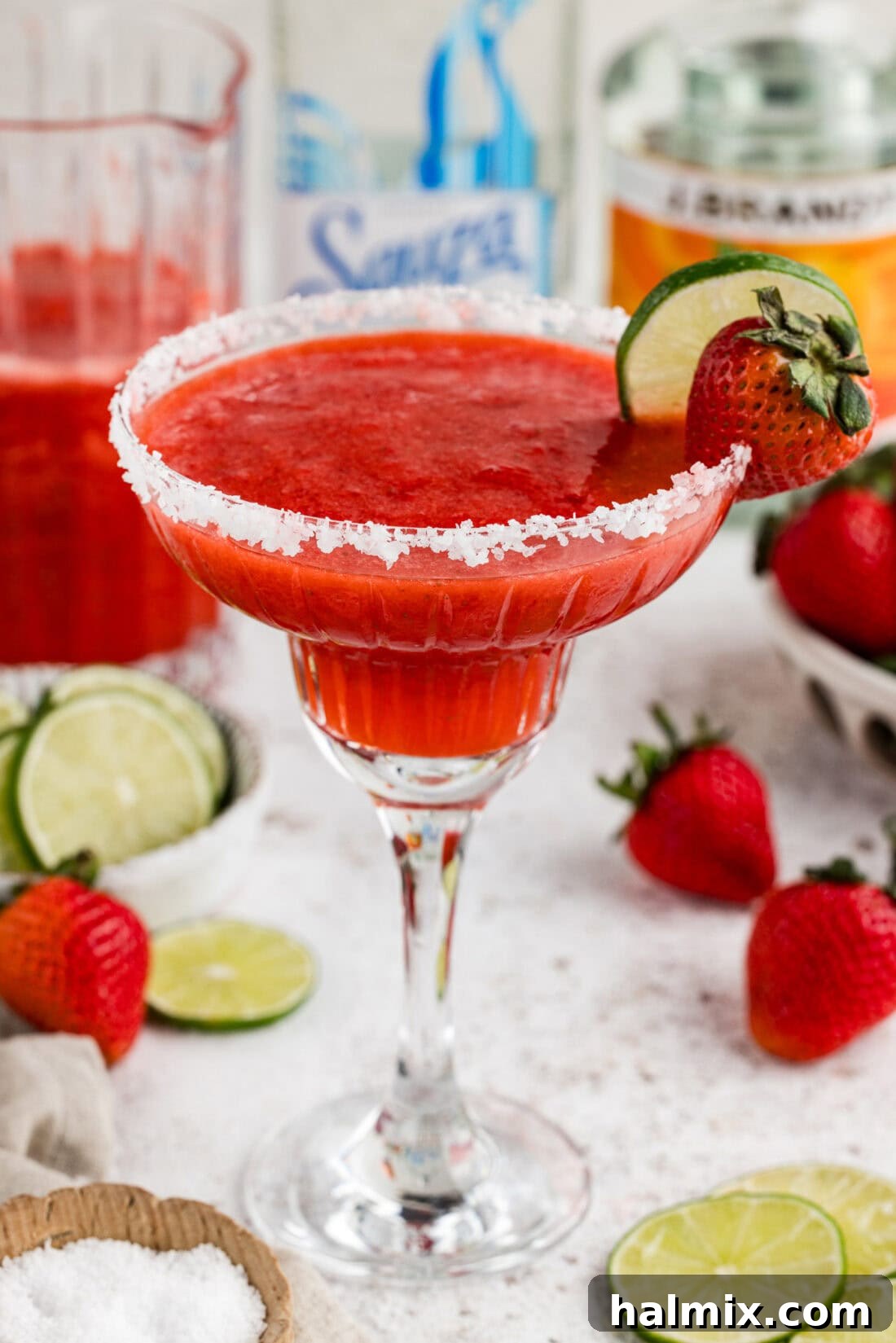 Close up photo of a vibrant Frozen Strawberry Margarita, showcasing its delightful texture and color
