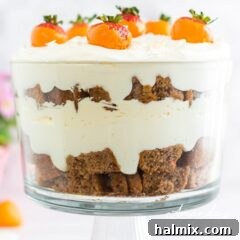 carrot cake trifle side view, showing all the layered components clearly in a glass bowl.