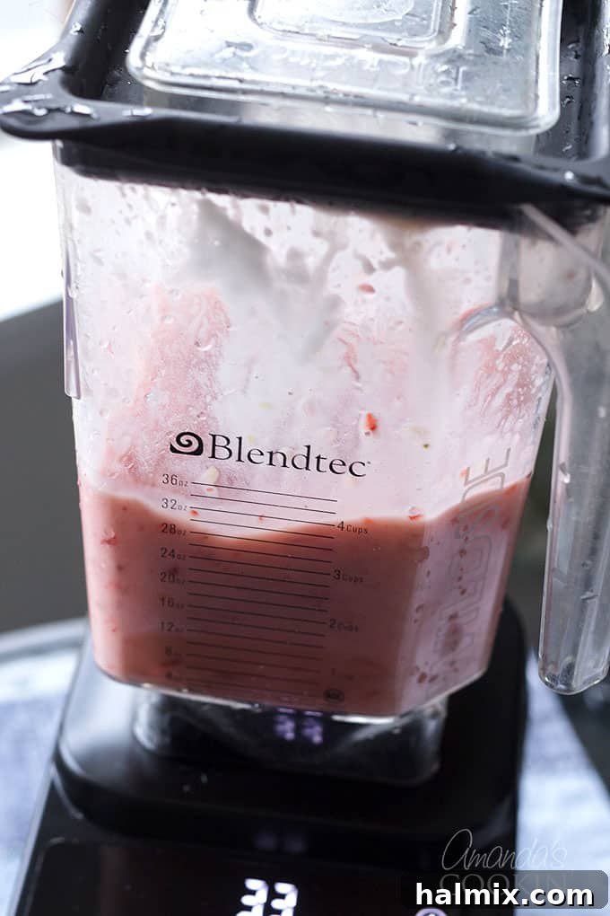 Using a high-powered blender to make dairy-free smoothies with frozen fruit and plant-based ingredients
