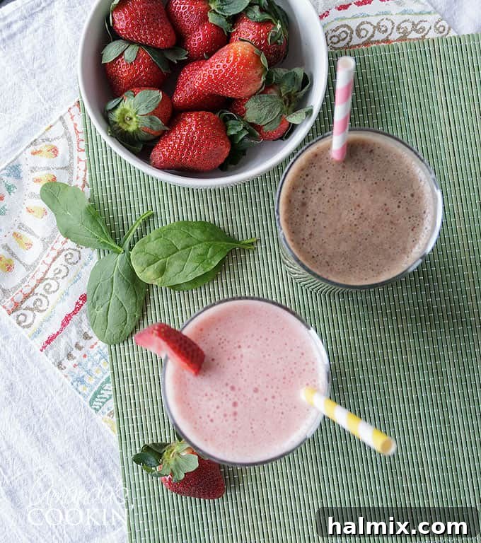 Non-dairy smoothie in a glass next to fresh ingredients like spinach and fruit