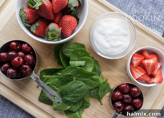 Fresh ingredients for vegan smoothies, including frozen fruit, almond milk, coconut yogurt, and spinach